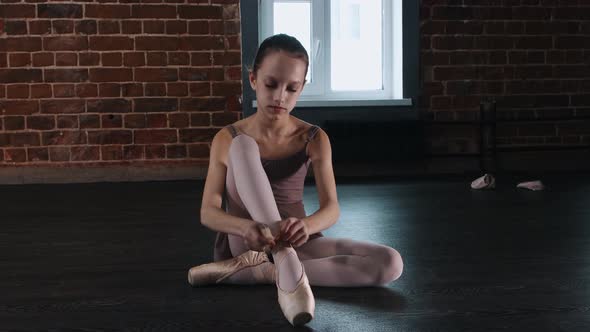 Ballet Dancing  a Little Girl Putting on Pointe Shoes