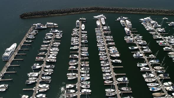 Boating Season With Big Expensive Boats Docked At Ocean Marina On Sunny Day alt