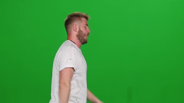 Portrait of Bearded Guy Calmly Is Running Then Stoped on Green Screen. Chroma Key. Profile View