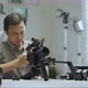 An Asian man is removing a series of camera rigs - VideoHive Item for Sale