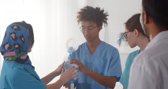 Team of Diverse Medical Interns Learning How to Use Breathing Bag