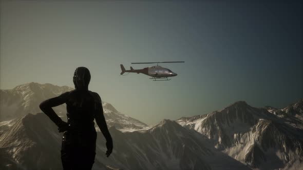 Woman and Helicopter in Winter Mountains