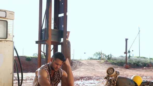 Man sitting at petrol pump station 4k