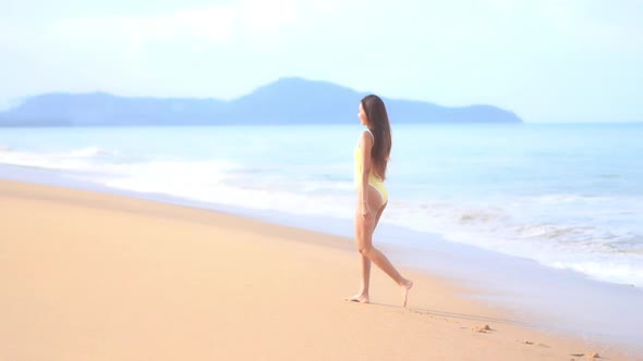 Asian woman enjoy around beautiful beach sea ocean