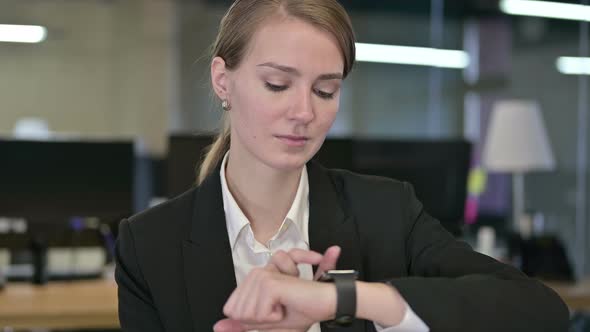 Portrait of Professional Young Businesswoman Using Smartwatch