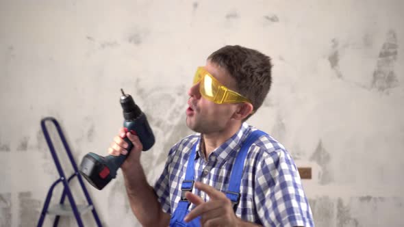 Cheerful Construction Worker Dancing on the Background of Repairs in the House. Funny Builder. 