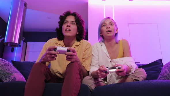 Young Girl Playing Video Games with Her Boyfriend and Sad About Losing To Him