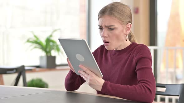 Failure Young Woman with Loss on Tablet in Office