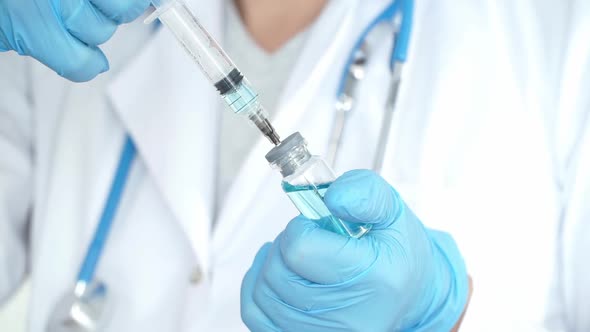 Doctors Hands Fills Syringe with Drug