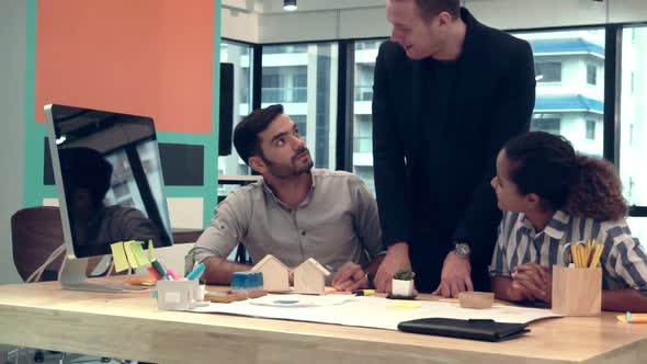 Creative Business People Group Having Conversation at Office Desk in Workplace