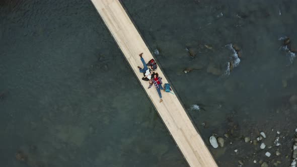 Mountain Bridge Couple Lying with Backpacks Resting Long Trip Enjoying Time