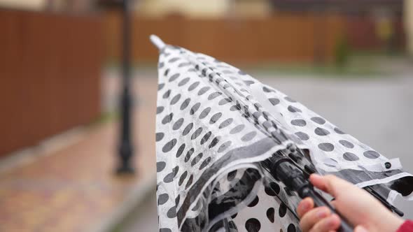 A Man's Hand Opens an Umbrella When It Starts to Rain