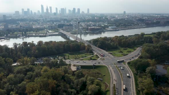 Aerial drone view of Warsaw skyline, Vistula river, Świętokrzyski Bridge and road junction in the fo