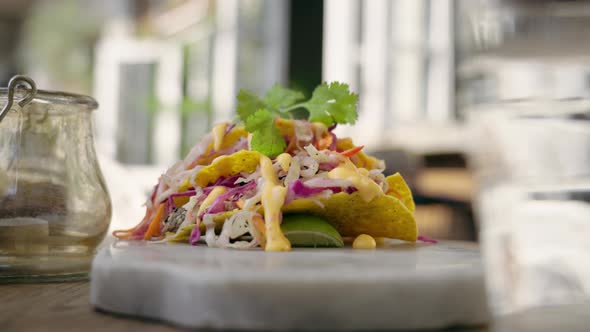 Caucasian man taking taco into his hand. Beautiful and bright mexican dish on a exquisite plate