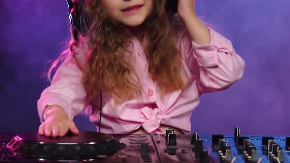 Little Girl in Headphones Plays for Dj Console. Slow Motion