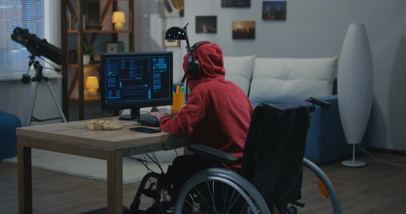 Disabled Boy Hacking on His Computer