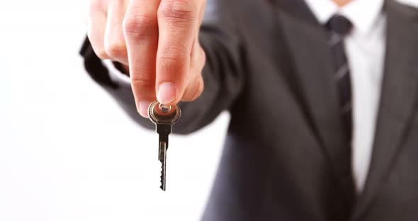 Mid-section of businessman holding keys