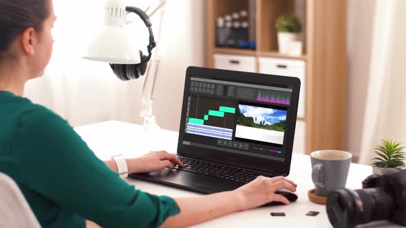 Woman with Video Editor Program on Laptop at Home
