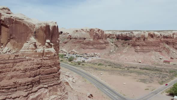 Sandstone Buttes and Red Rock Formations by Desert Road in Southwest Desert of Utah - Aerial