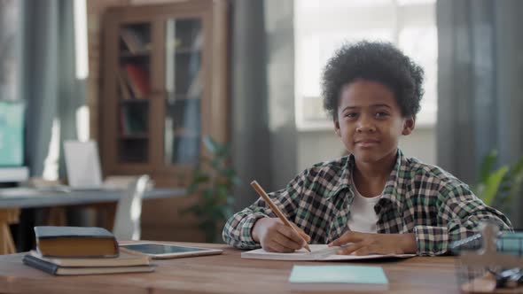 Portrait Of Afro Boy Studying At Home