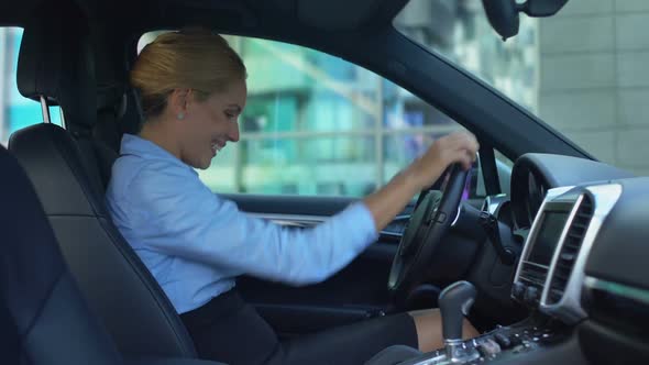 Naive Blonde Delighted With New Car, Touches Random Buttons, Joyful as Child