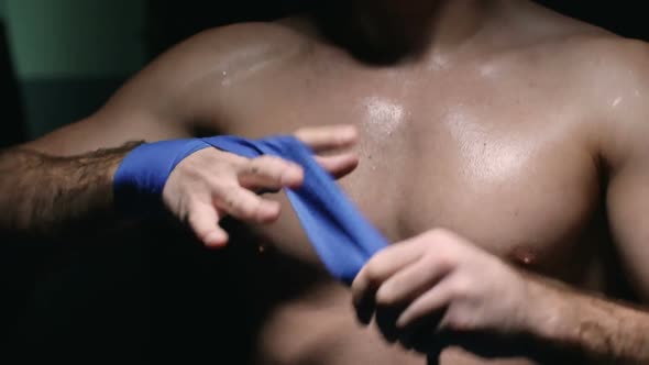 Professional Fighter Wrapping Hand in Tape