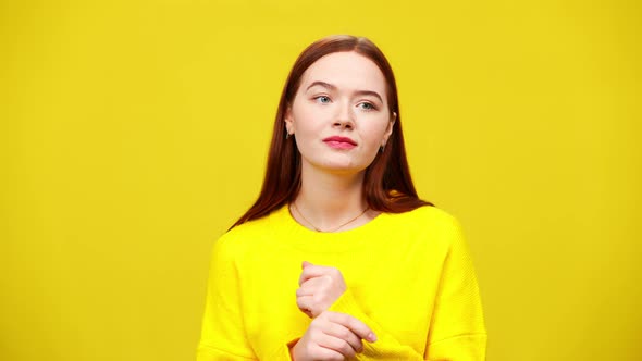 Charming Young Redhead Caucasian Woman Dancing at Yellow Background in Slow Motion