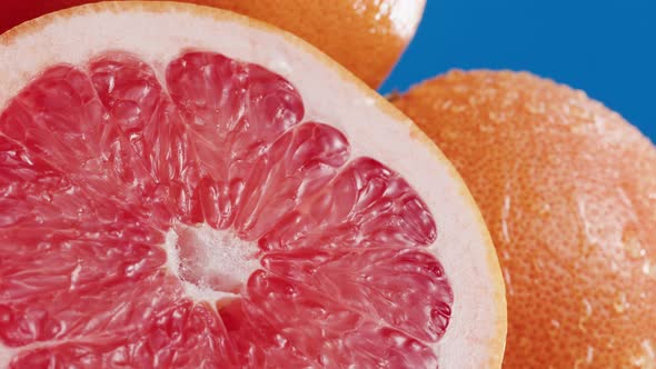 Grapefruits Isolated on Blue Background Pouring Water on Fresh and Ripe Citrus Fruits