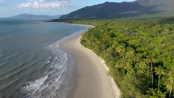 Cape Tribulation backward aerial of sunny Myall beach, in Daintree Rainforest, Queensland, Australia