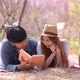 Happy young couple dating while pink Sakura park on Valentine day. - VideoHive Item for Sale