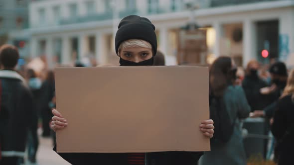 Protest and Demonstrations. Rebellious Woman with Face Mask Striking 