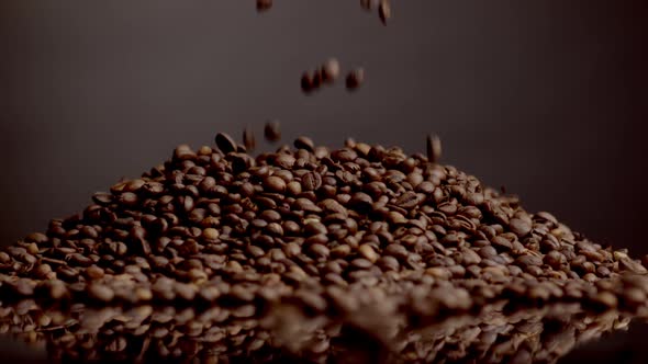 Roasted Coffee Beans Pouring on Heap Close Up