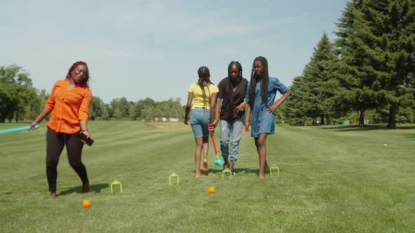 Excited Black Mom and Teenage Girls Enjoying Active Lifestyle in Summer Nature