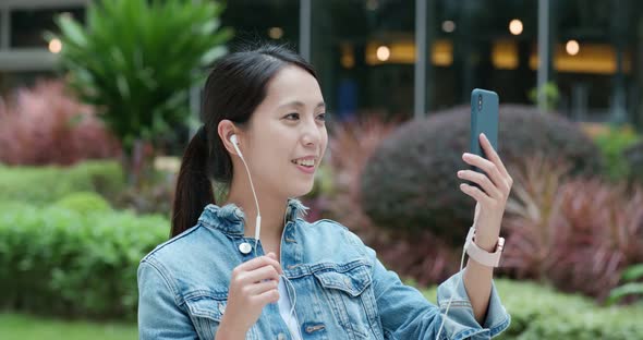 Woman hold with mobile phone in city