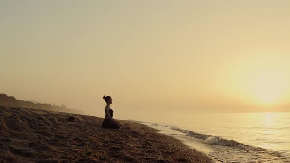 Focused Woman Practicing Meditation on Beach