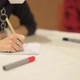 Girl Writes at the Event with a Pencil Marker on a Sheet - VideoHive Item for Sale