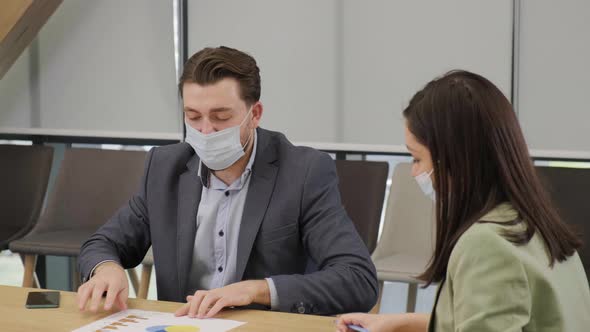 Business People Having a Meeting Working in the Office Wearing Medical Mask