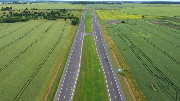 Asphalt Highway Through Green Summer Field