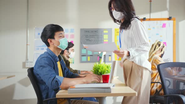 Young creative designer agency in protective face mask for protect pandemic virus