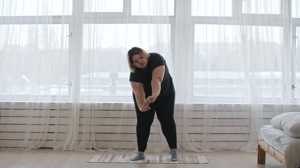 A Fat Woman Doing Stretching Up Exercises at Home