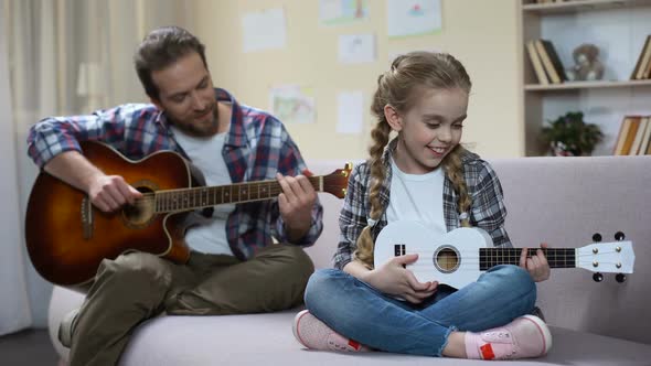 Dad With Guitar and Daughter With Ukulele Playing Song, Competition Rehearsal