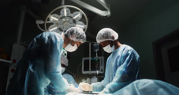 A Team of Surgeons Perform an Operation in a Bright Operating Room