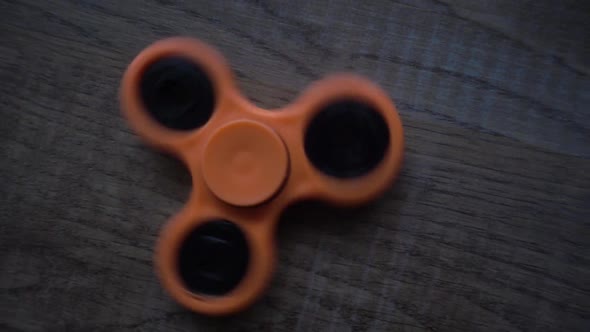 Fidget Spinner Spinning On A Wooden Table