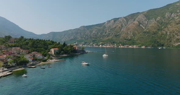 flying over a ship and passing by church in kotor bay