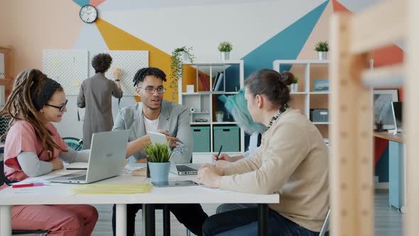 Slow Motion of Multi-ethnic Business Team Discussing Work in Creative Office