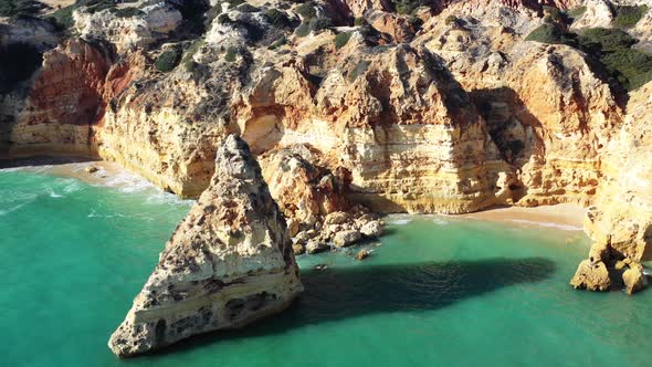 Eroded rock formations in Marinha Beach south of Portugal, Aerial approach shot