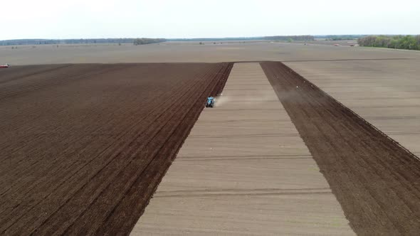 Aero. Tractor with Special Trailer Plows Land, Soil, Makes on Soil Field Furrows for Further