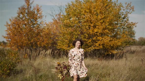 Woman Walking on a Meadow in Summer