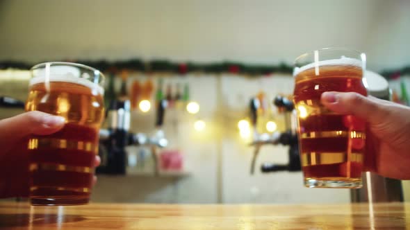 Toasting with Foamy Beer in Glasses Closeup