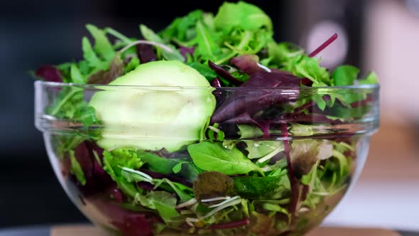 Fresh salad plate with mixed greens lettuce leaves (arugula, mesclun, mache)